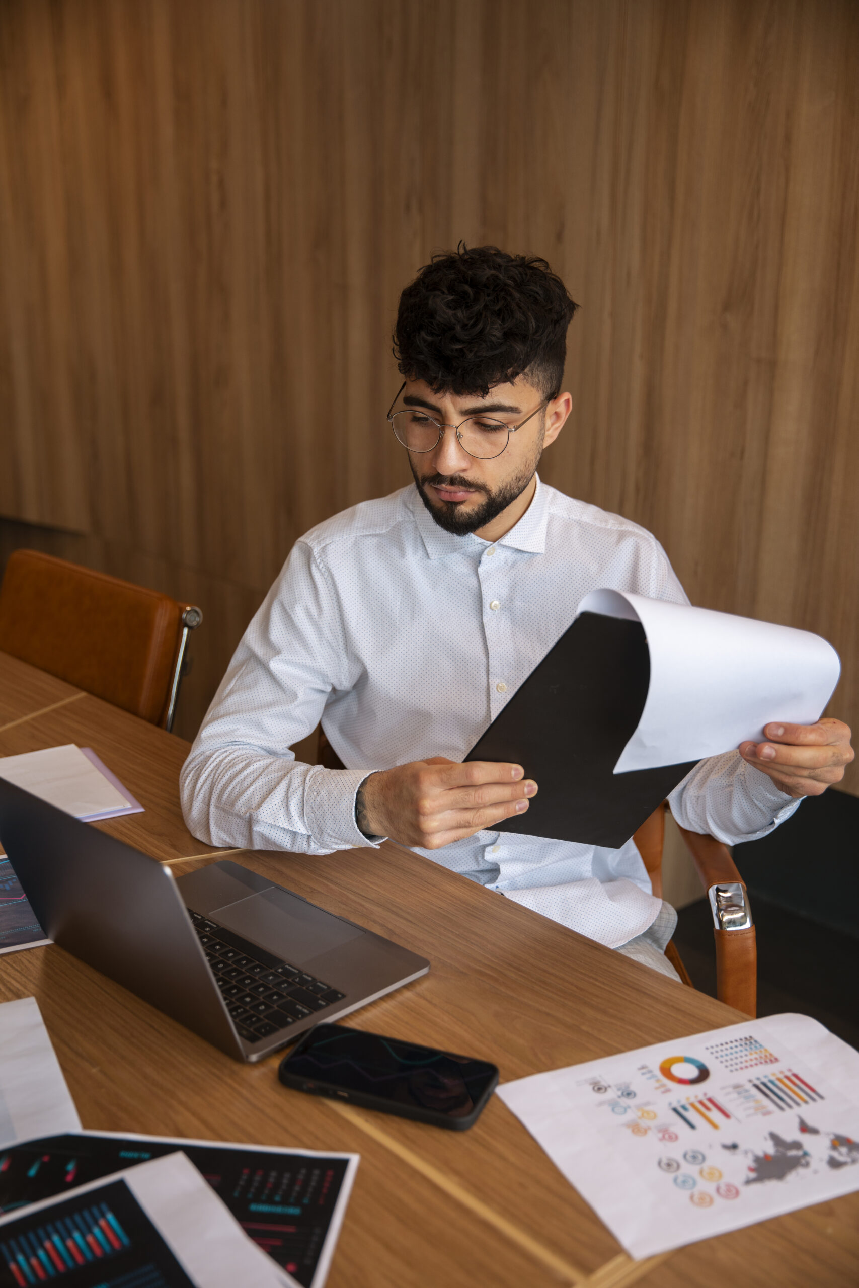 Home office worker using finance graphs scaled.jpg